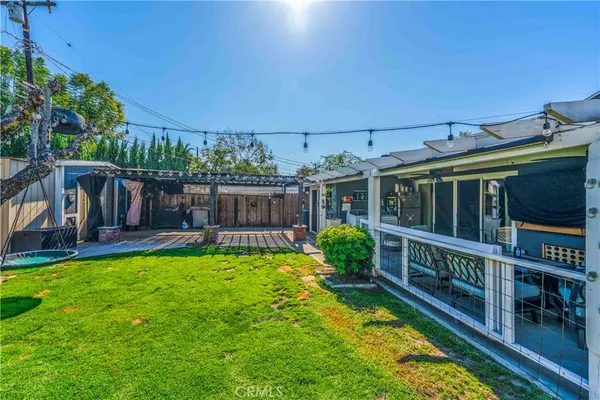 a view of a house with backyard and sitting area