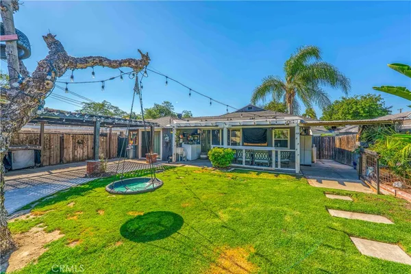 a view of a house with swimming pool and a yard