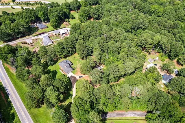 an aerial view of a house with a yard