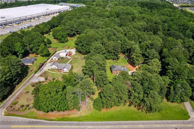 an aerial view of a house with a yard