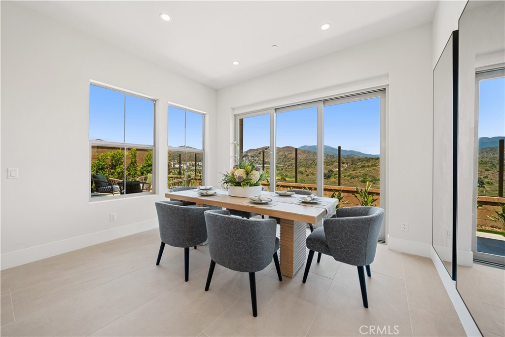 122 Mossvine Irvine, CA 92618 - Photo 11 of 44 a view of a dining room that has a table and chairs in it