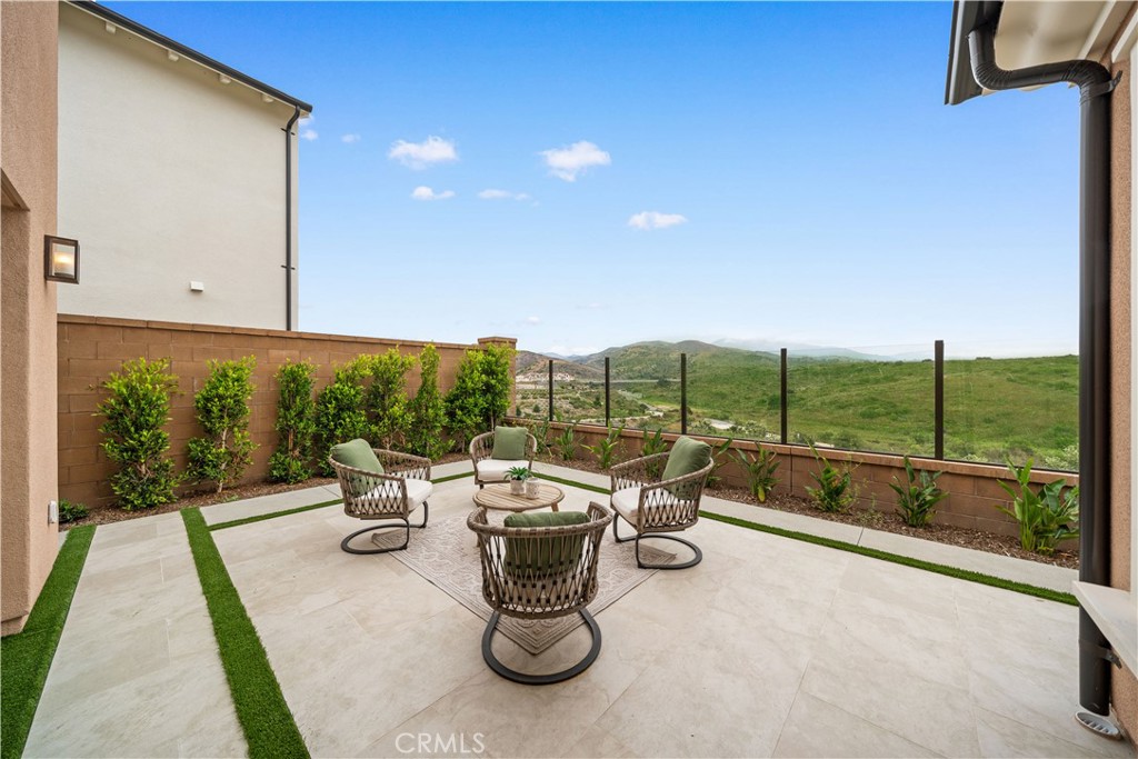 122 Mossvine Irvine, CA 92618 - Photo 18 of 44 a view of roof deck with table and chairs potted plants with sky view