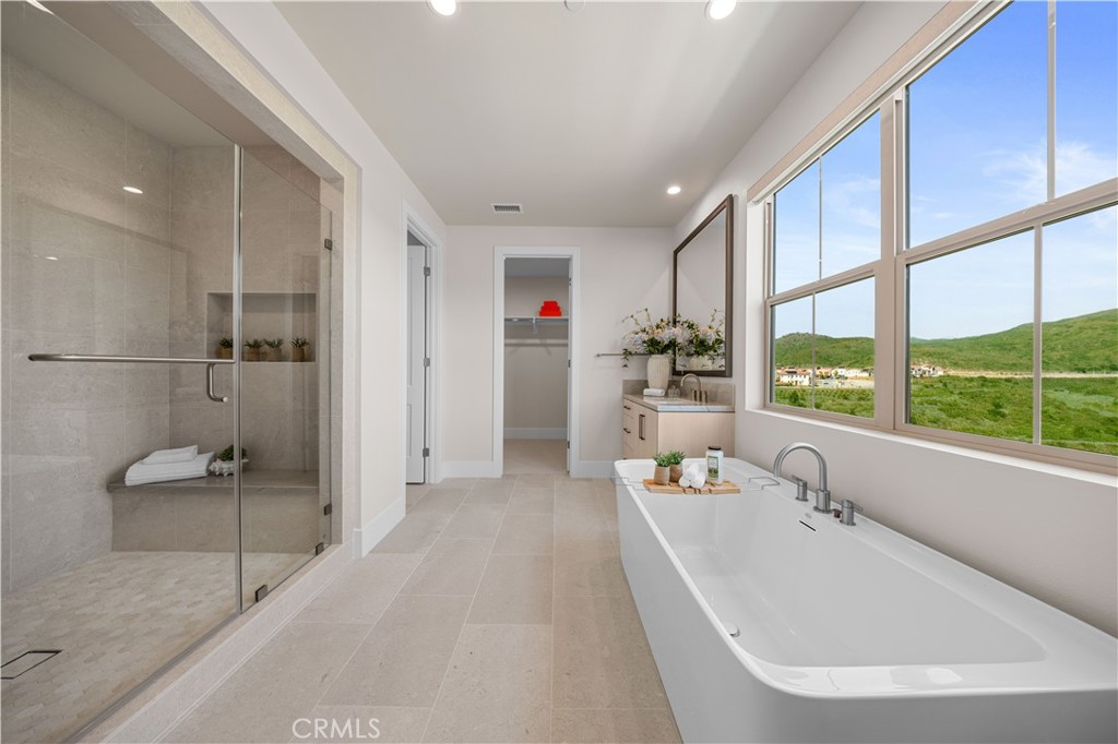 122 Mossvine Irvine, CA 92618 - Photo 30 of 44 a bathroom with a tub sink and large window