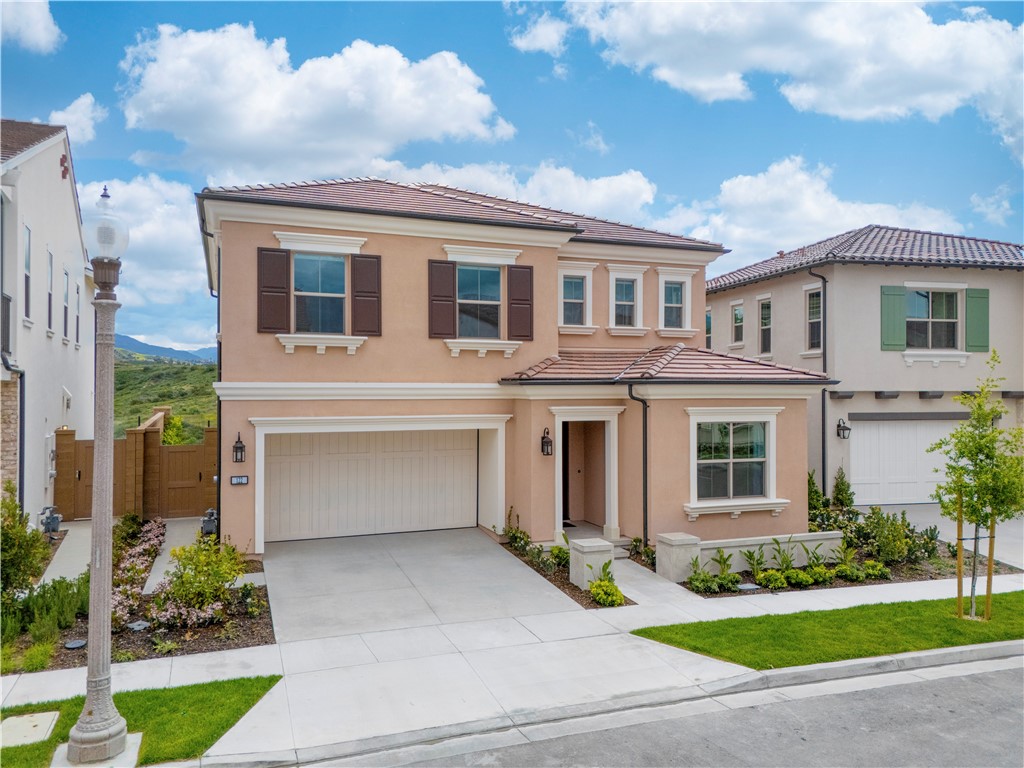 122 Mossvine Irvine, CA 92618 - Photo 3 of 44 a front view of a house with a yard and garage