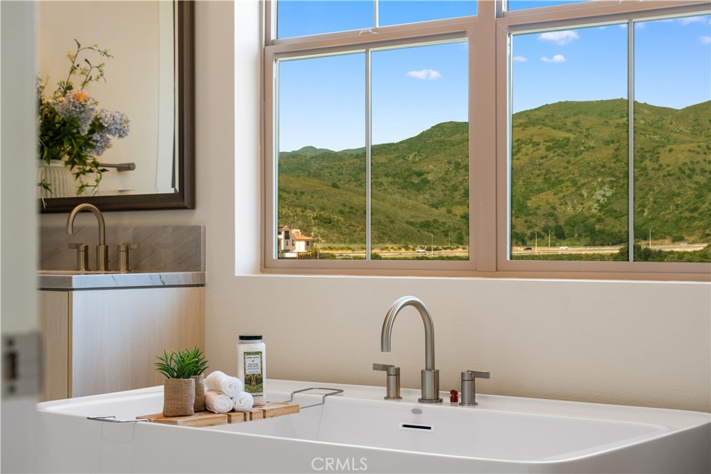 122 Mossvine Irvine, CA 92618 - Photo 32 of 44 a bathroom with a sink and a mirror