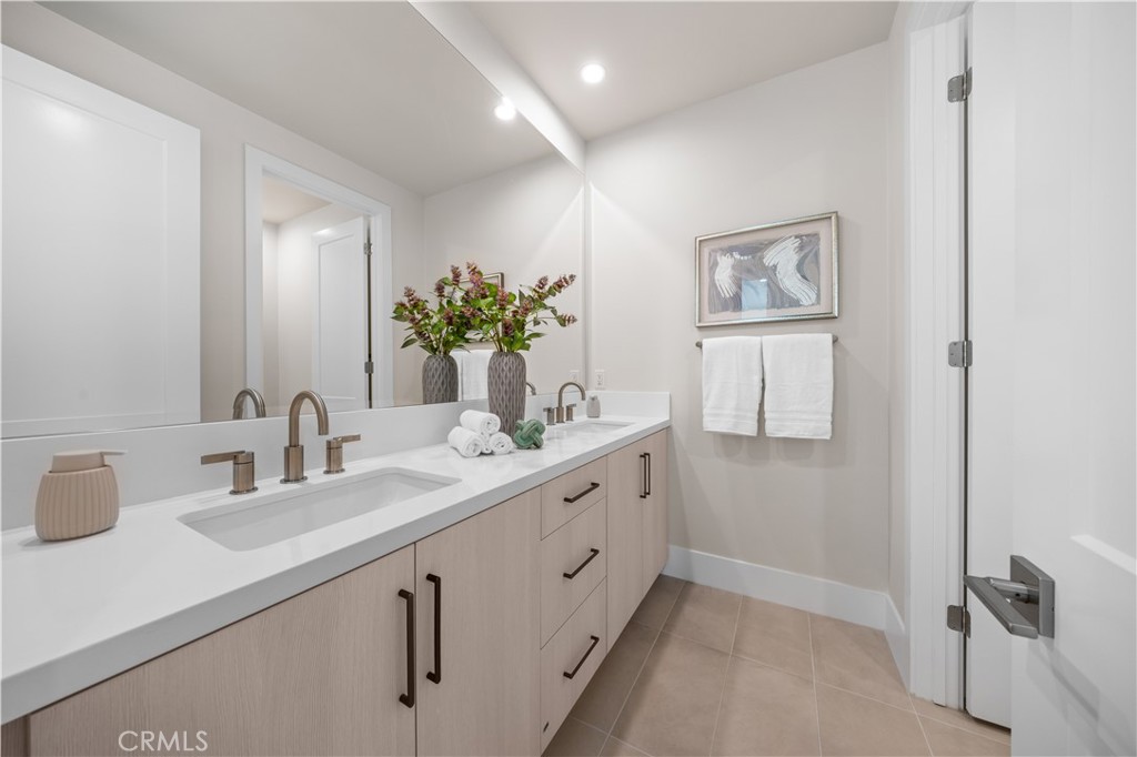 122 Mossvine Irvine, CA 92618 - Photo 38 of 44 a bathroom with a double vanity sink and a mirror