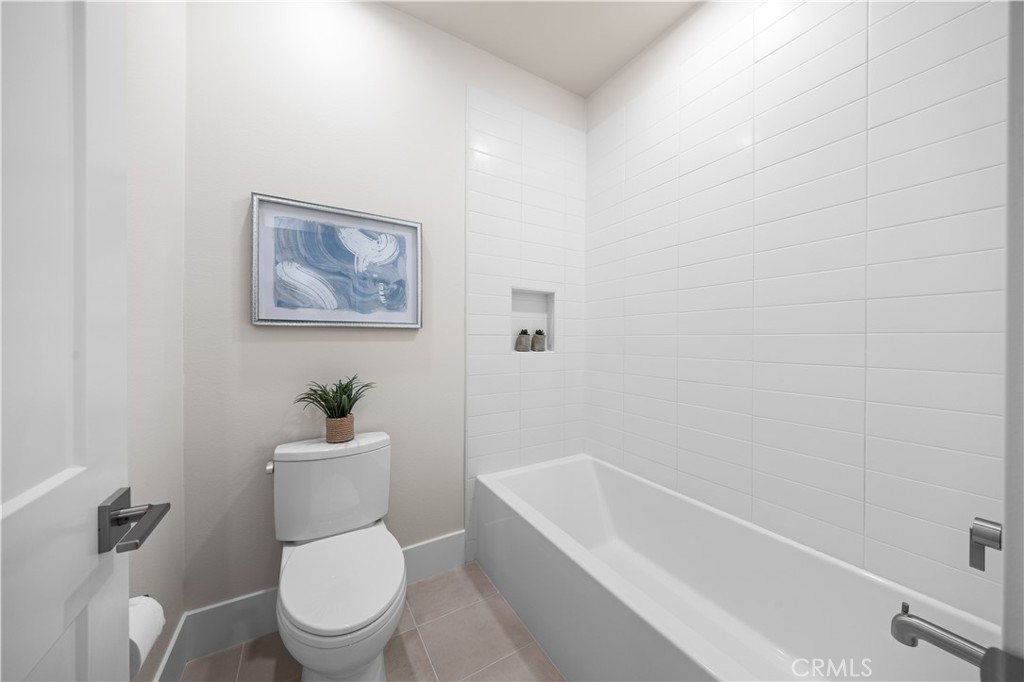 122 Mossvine Irvine, CA 92618 - Photo 39 of 44 a white toilet sitting next to a bath tub