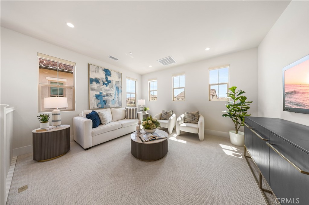 122 Mossvine Irvine, CA 92618 - Photo 40 of 44 a living room with furniture and a potted plant