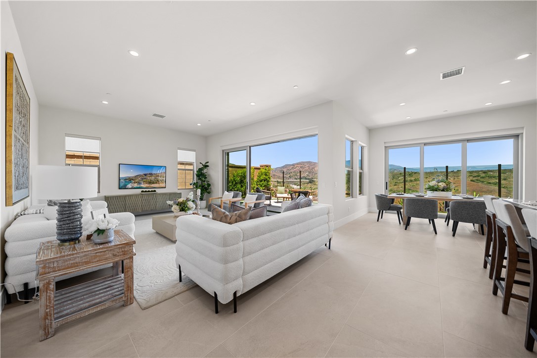 122 Mossvine Irvine, CA 92618 - Photo 4 of 44 a living room with furniture and a large window