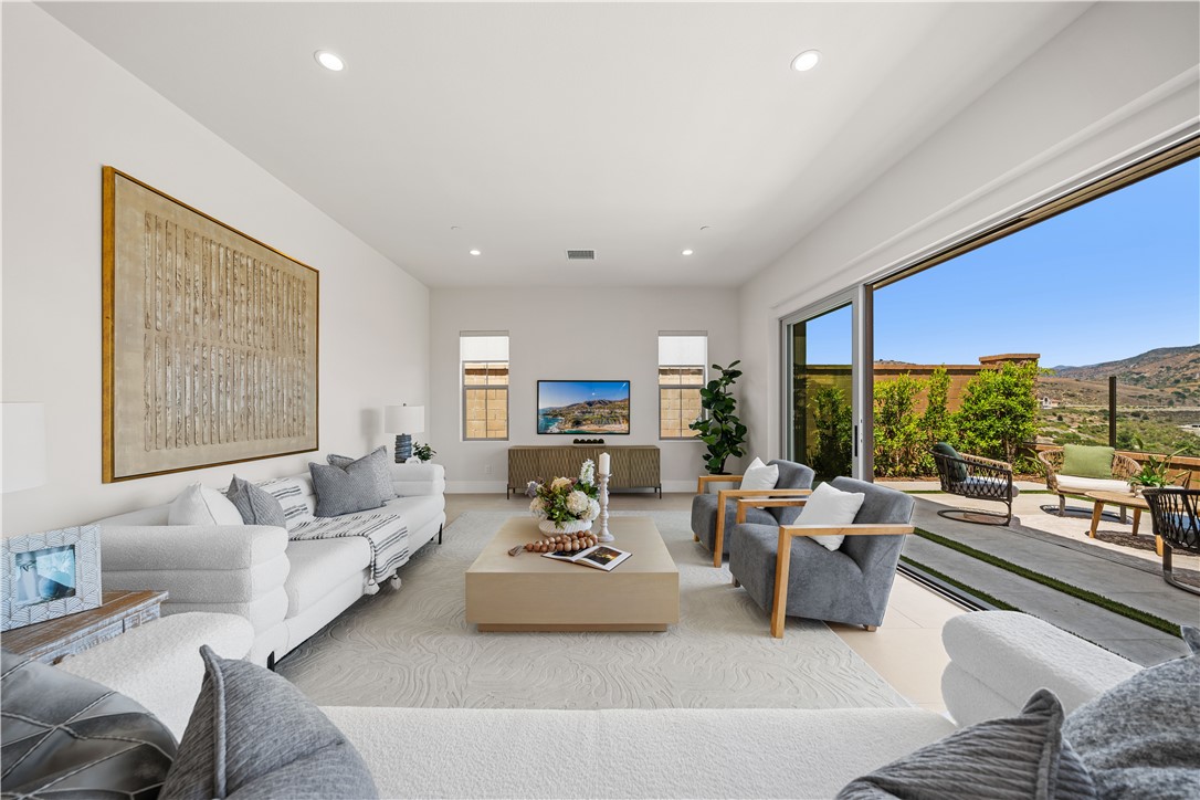 122 Mossvine Irvine, CA 92618 - Photo 5 of 44 a living room with furniture and a large window