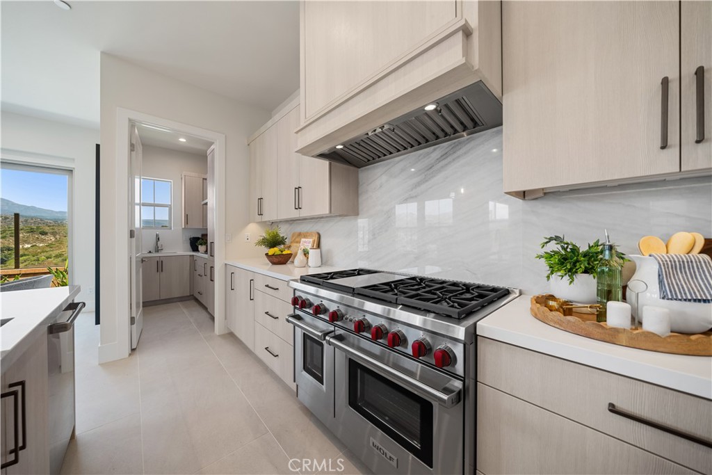 122 Mossvine Irvine, CA 92618 - Photo 9 of 44 a kitchen with stainless steel appliances granite countertop a stove and a refrigerator