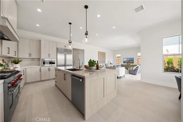 a kitchen with white cabinets and sink
