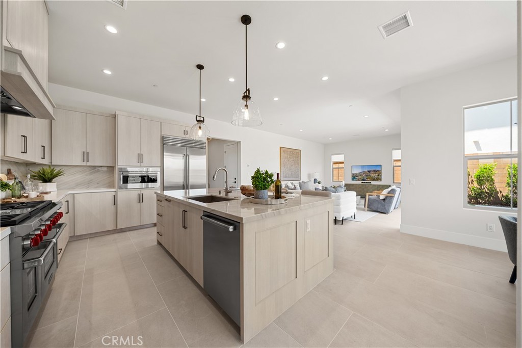 122 Mossvine Irvine, CA 92618 - Photo 10 of 44 a kitchen with white cabinets and sink