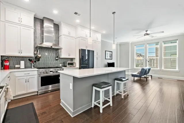 a kitchen with white cabinets and sink