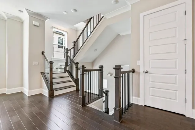 a view of a hallway with wooden floor and entryway