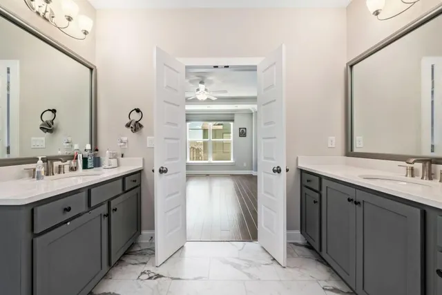 a spacious bathroom with a double vanity sink mirror and