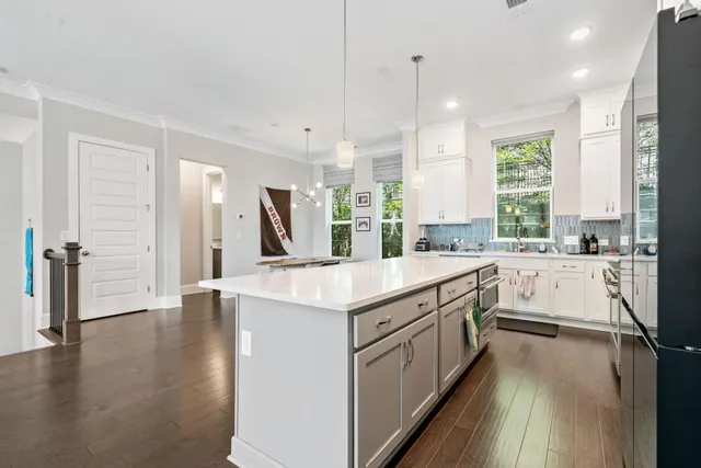 a kitchen with a stove a sink and a refrigerator