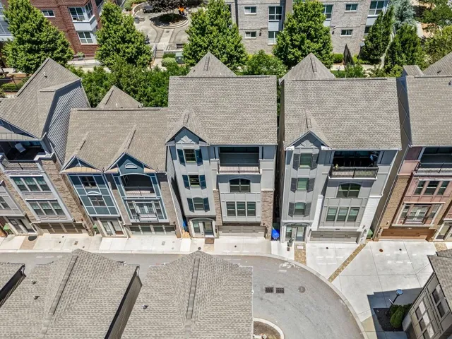 an aerial view of a house with swimming pool and sitting area