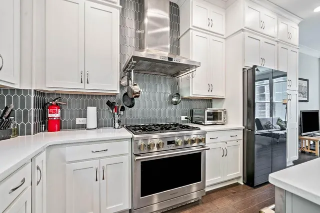 a kitchen with stainless steel appliances granite countertop a stove and a refrigerator