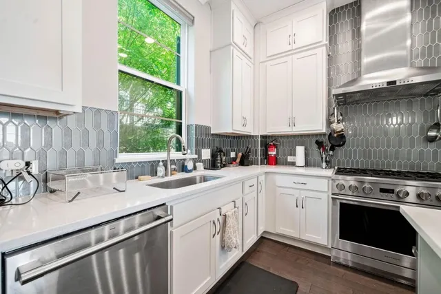 a kitchen with appliances a sink and cabinets