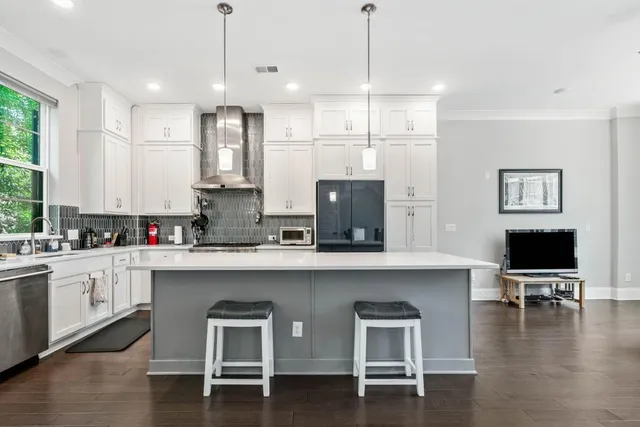 a large white kitchen with lots of counter space and appliances