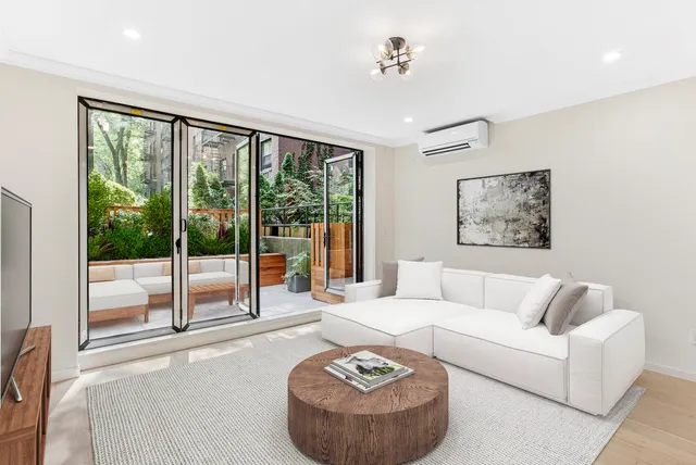 a living room with furniture and a floor to ceiling window