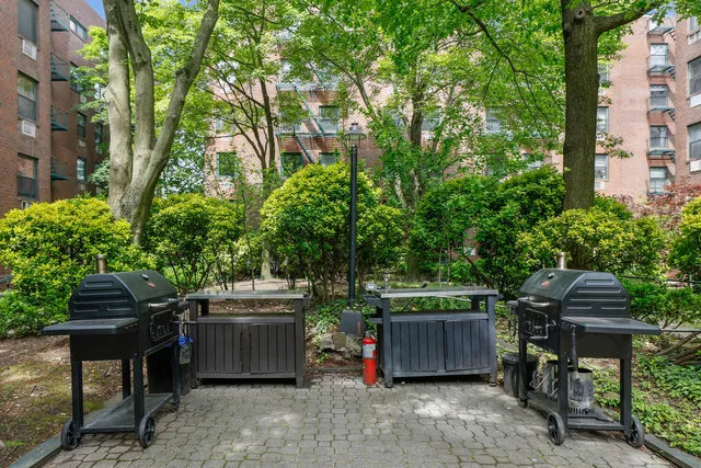 a view of a lake with a bench and trees around