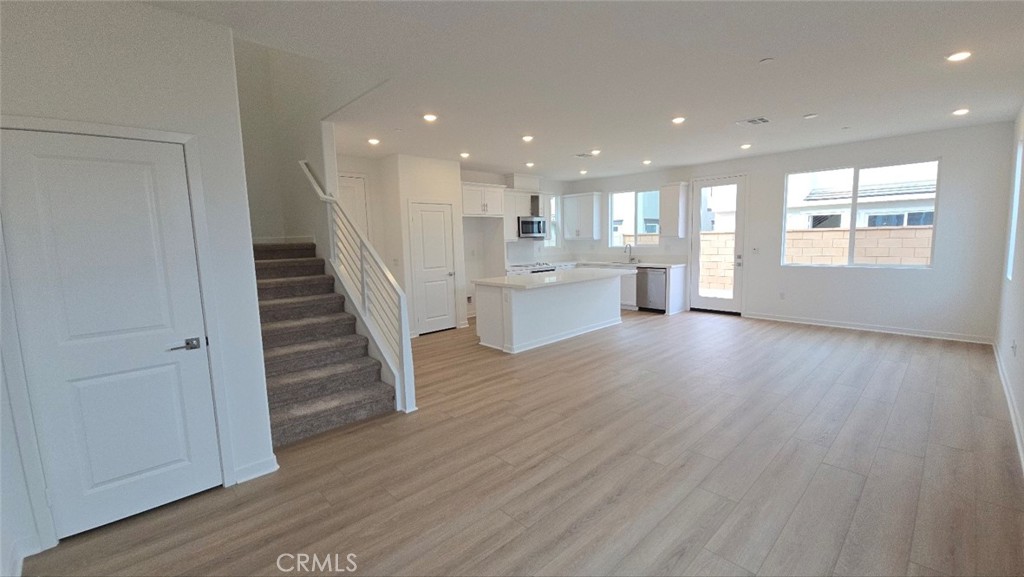 3256 Sprout Paseo Ontario, CA 91761 - Photo 13 of 44 a view of an empty room with wooden floor and a window