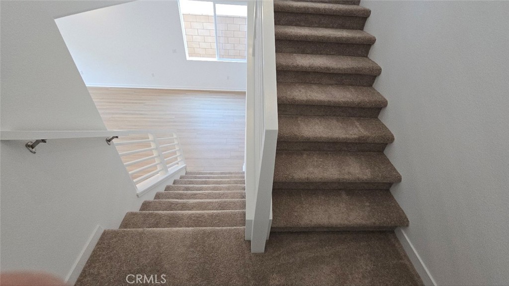 3256 Sprout Paseo Ontario, CA 91761 - Photo 19 of 44 a view of staircase with white walls
