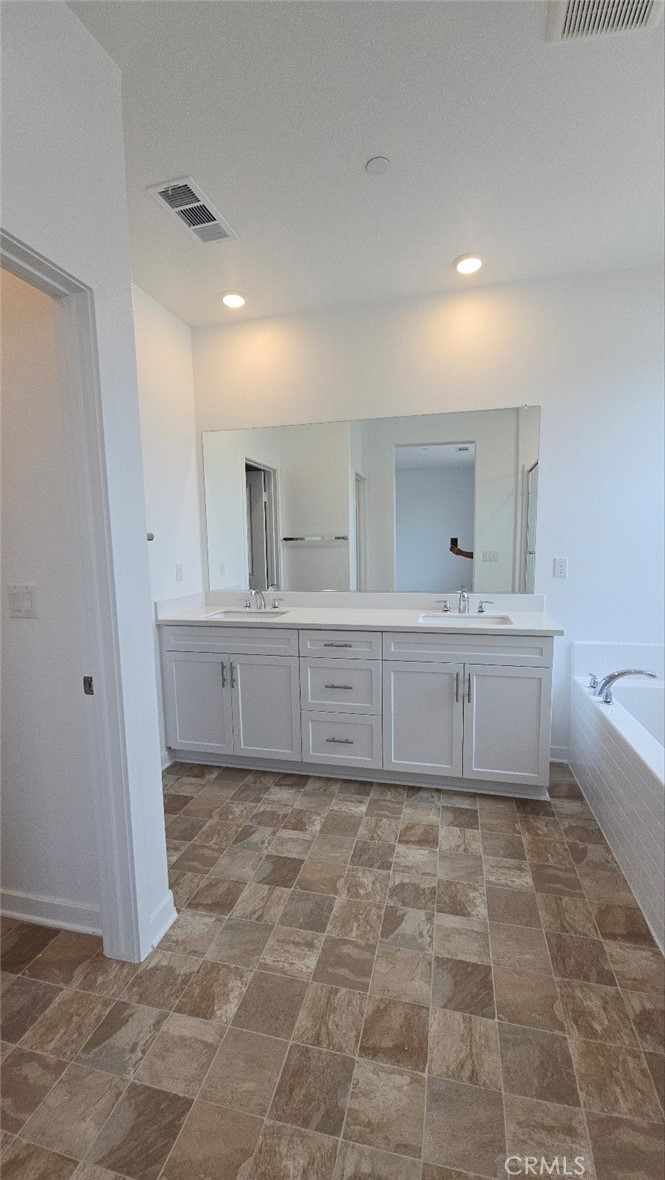 3256 Sprout Paseo Ontario, CA 91761 - Photo 23 of 44 a bathroom with a sink a toilet and mirror