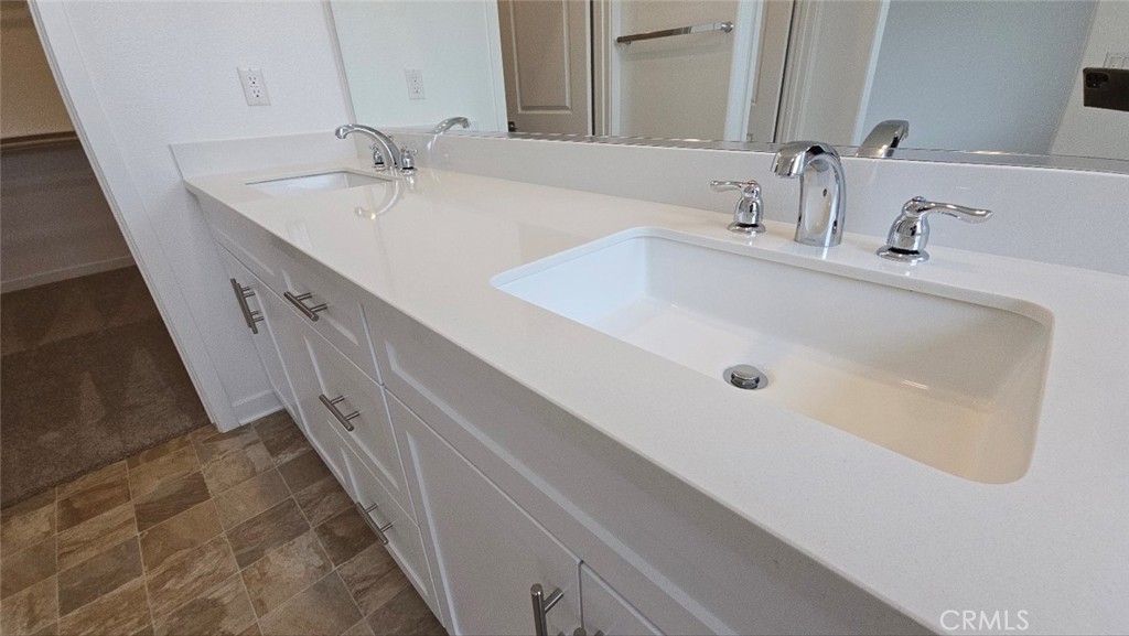 3256 Sprout Paseo Ontario, CA 91761 - Photo 24 of 44 a bathroom with double vanity sink and a mirror