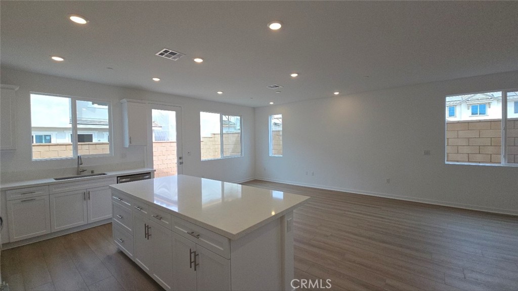 3256 Sprout Paseo Ontario, CA 91761 - Photo 3 of 44 a large kitchen with granite countertop a large counter top and sink