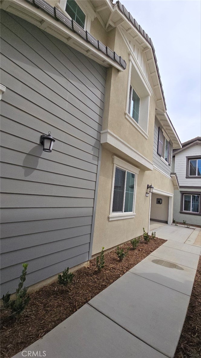 3256 Sprout Paseo Ontario, CA 91761 - Photo 40 of 44 a front view of a house with white fence