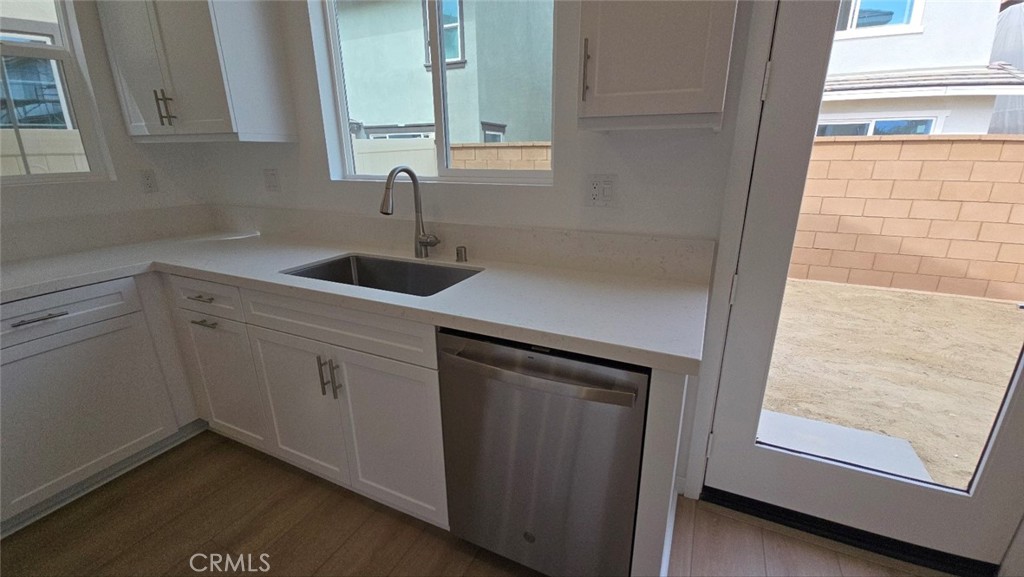 3256 Sprout Paseo Ontario, CA 91761 - Photo 7 of 44 a kitchen with a sink and cabinets