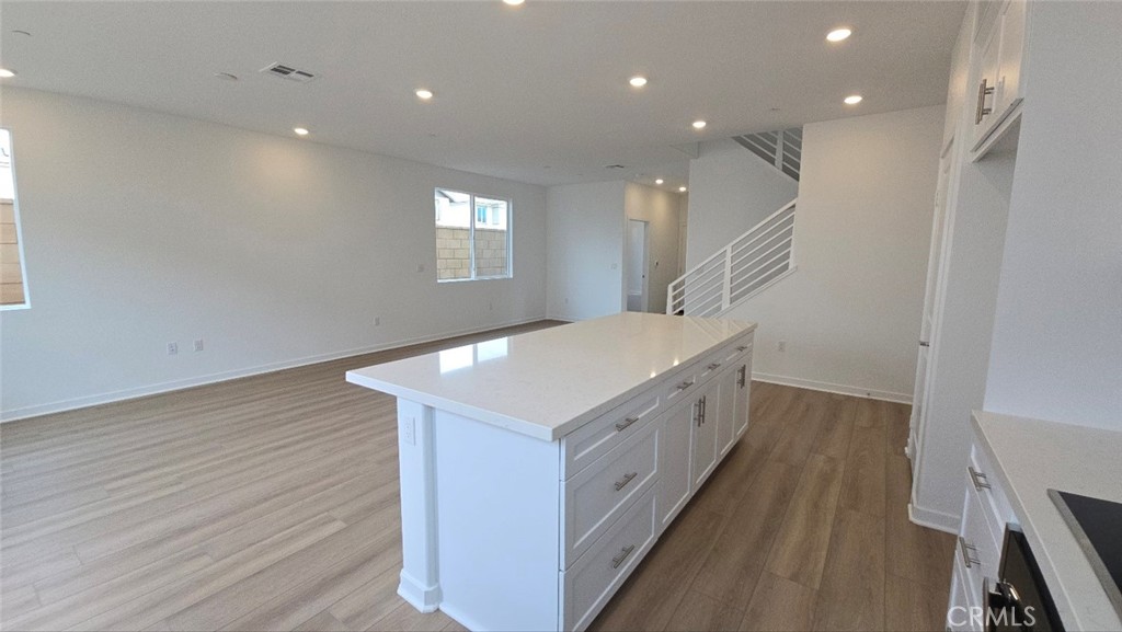 3256 Sprout Paseo Ontario, CA 91761 - Photo 9 of 44 a kitchen with a sink and wooden floor