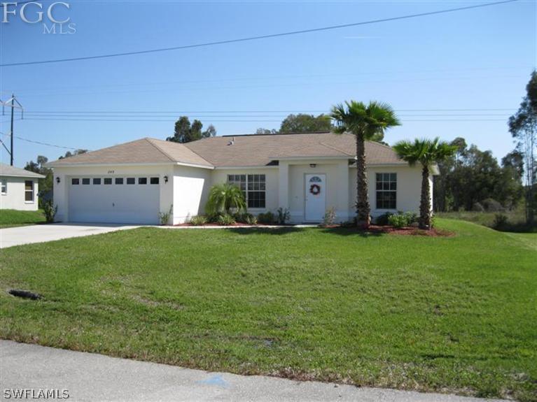 245 Rue Labonne Road Fort Myers, FL 33913 - Photo 1 of 18 a front view of a house with a garden