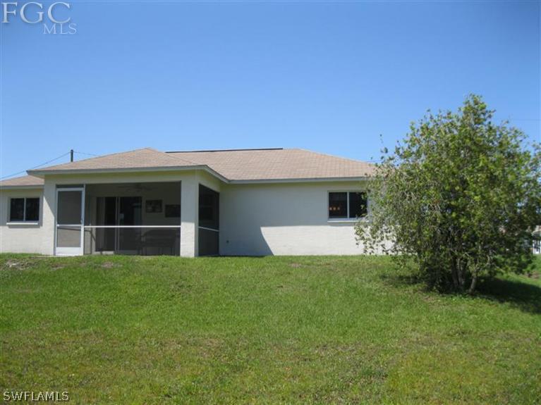 245 Rue Labonne Road Fort Myers, FL 33913 - Photo 17 of 18 a front view of a house with a garden