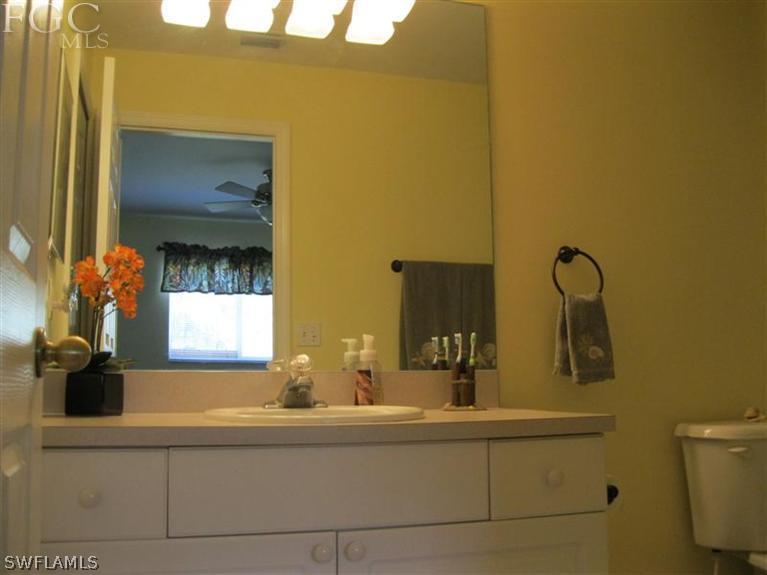 245 Rue Labonne Road Fort Myers, FL 33913 - Photo 8 of 18 a bathroom with a sink and a mirror