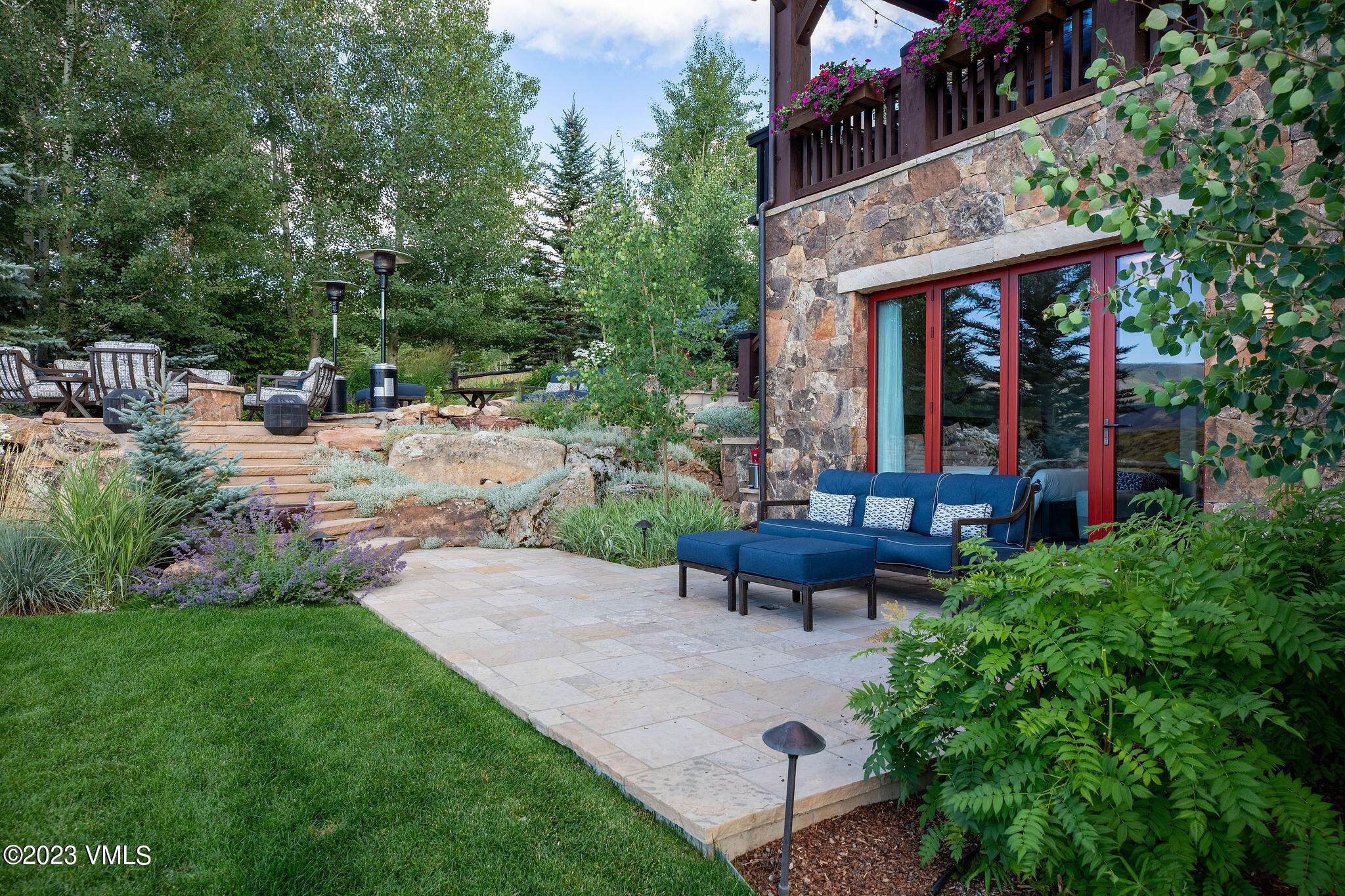 520 Old Creamery Road Edwards, CO 81632 - Photo 46 of 78 a view of a patio with table and chairs potted plants and large tree