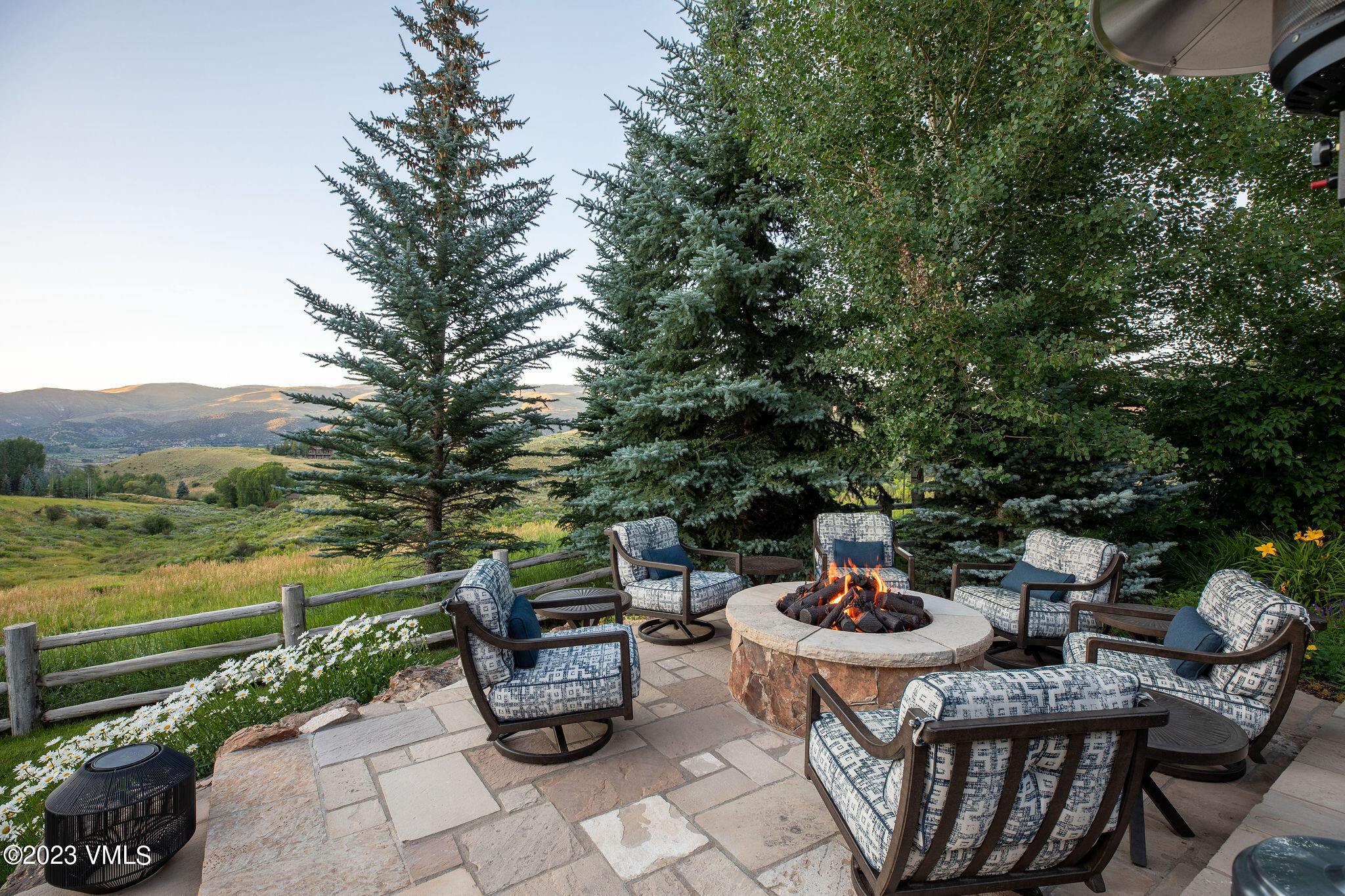 520 Old Creamery Road Edwards, CO 81632 - Photo 58 of 78 a table and chairs sitting in the middle of a garden