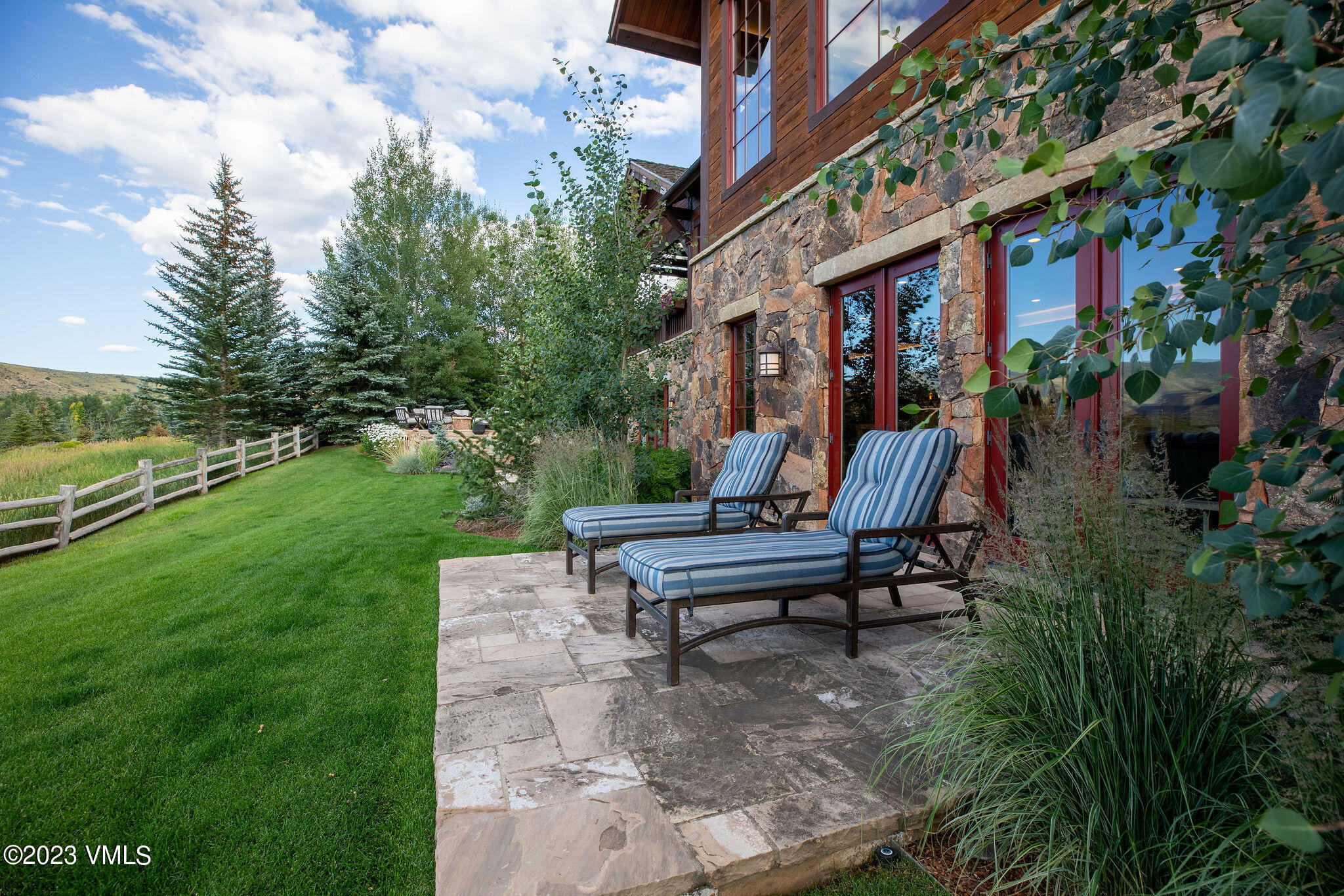 520 Old Creamery Road Edwards, CO 81632 - Photo 64 of 78 a view of a patio with table and chairs potted plants and a large tree