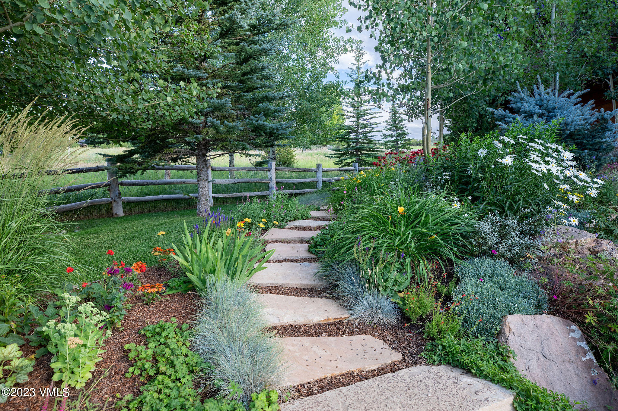 520 Old Creamery Road Edwards, CO 81632 - Photo 65 of 78 a backyard of a house with lots of green space and plants