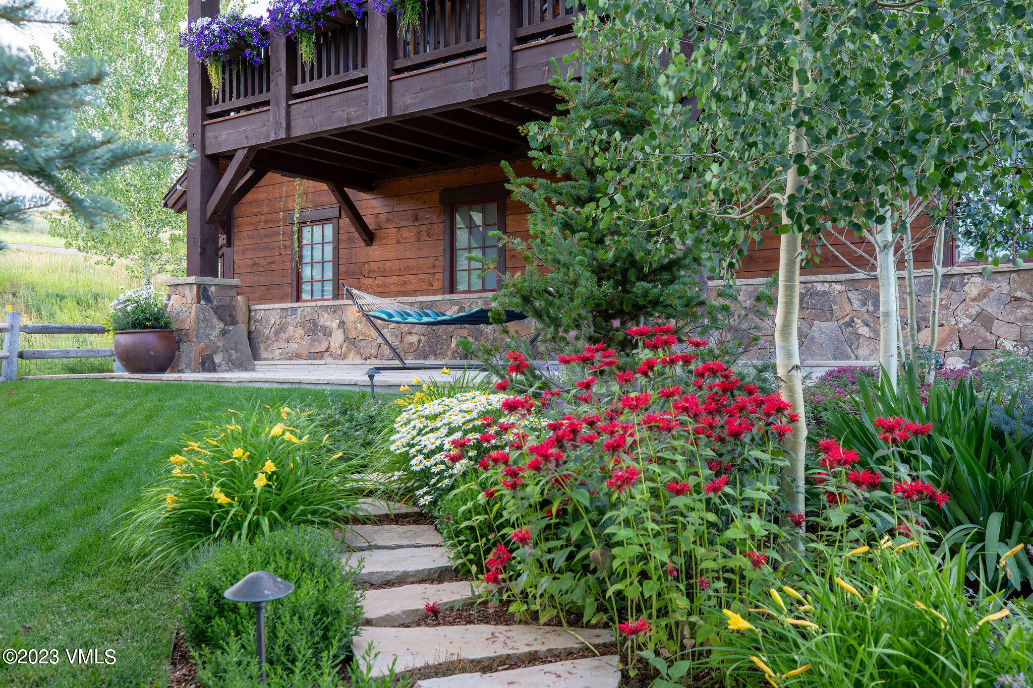 520 Old Creamery Road Edwards, CO 81632 - Photo 66 of 78 a backyard of a house with lots of flowers and trees
