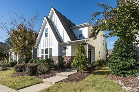 a front view of house with yard and trees around