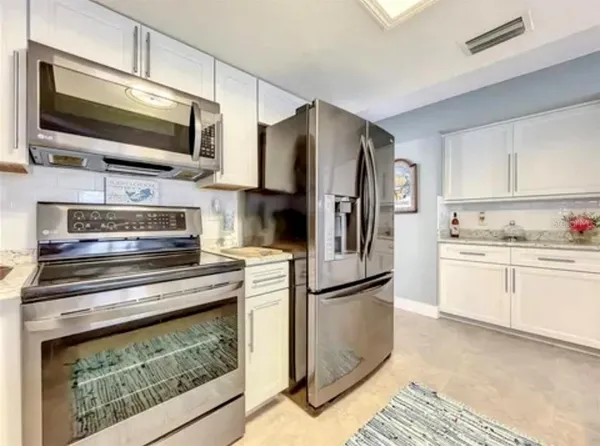 a kitchen with a refrigerator stove and microwave