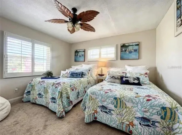 a bedroom with two beds and a chandelier