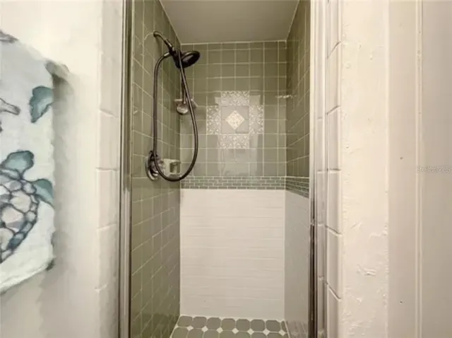 a bathroom with a glass shower door