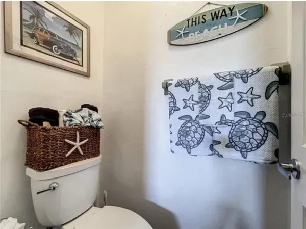 a bathroom with a toilet a sink and a shower curtain