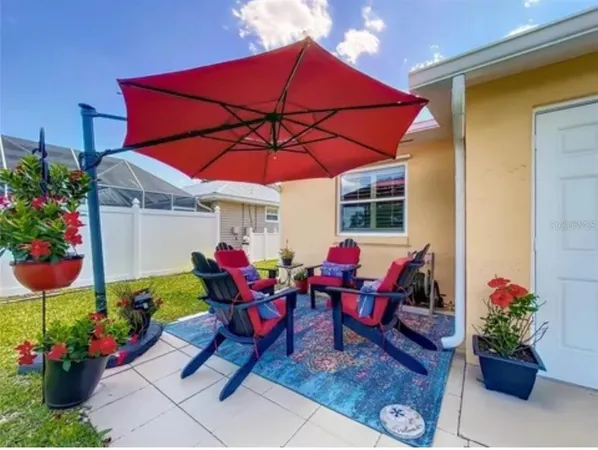 a view of a lounge chairs in patio with a yard