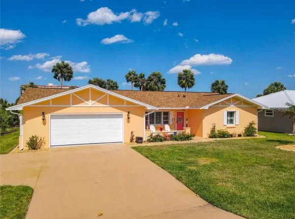 a view of a house with a yard and garage